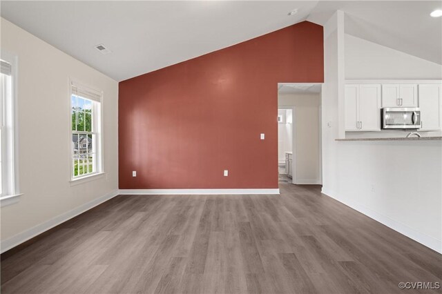 15631 Corte Castle Ter, Chesterfield, VA 23838 - unfurnished living room with wood finished floors, baseboards, and high vaulted ceiling