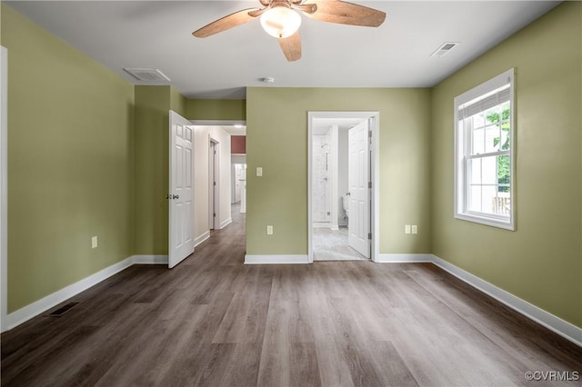 15631 Corte Castle Ter, Chesterfield, VA 23838 - unfurnished bedroom featuring dark wood finished floors, baseboards, connected bathroom, and a ceiling fan