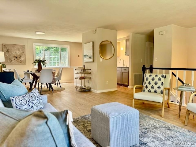 7534 Hollyleaf Ct, Chesterfield, VA 23234 - living area featuring light wood-style flooring and baseboards