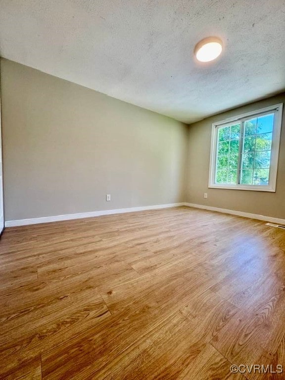7534 Hollyleaf Ct, Chesterfield, VA 23234 - spare room featuring wood finished floors, a textured ceiling, and baseboards