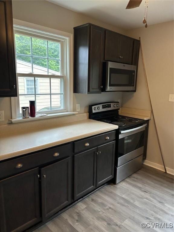 113 N Fern Ave, Highland Springs, VA 23075 - kitchen with appliances with stainless steel finishes, light wood-style flooring, light countertops, and baseboards