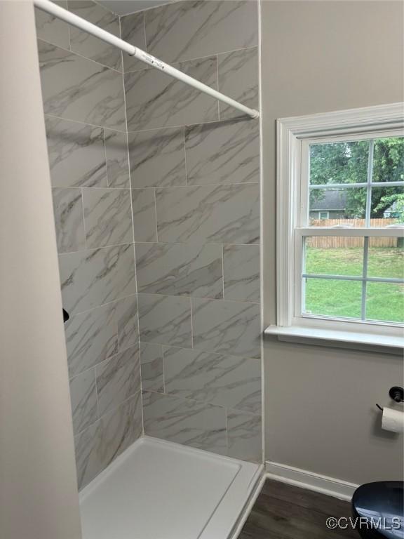 113 N Fern Ave, Highland Springs, VA 23075 - bathroom with tiled shower, plenty of natural light, and baseboards