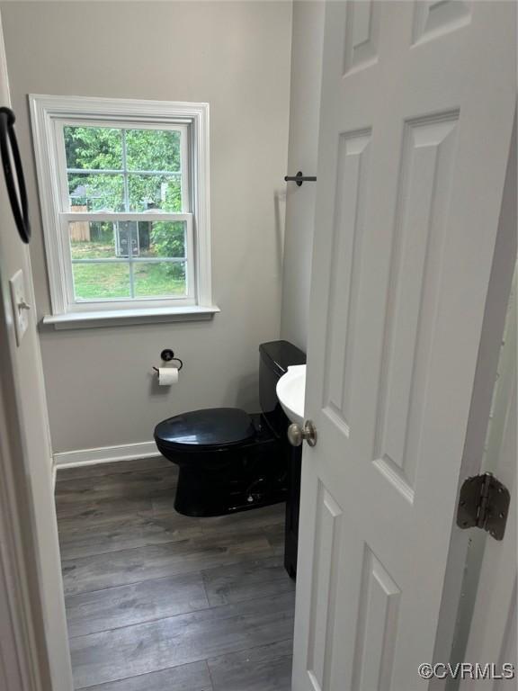 113 N Fern Ave, Highland Springs, VA 23075 - bathroom with wood finished floors, toilet, and baseboards