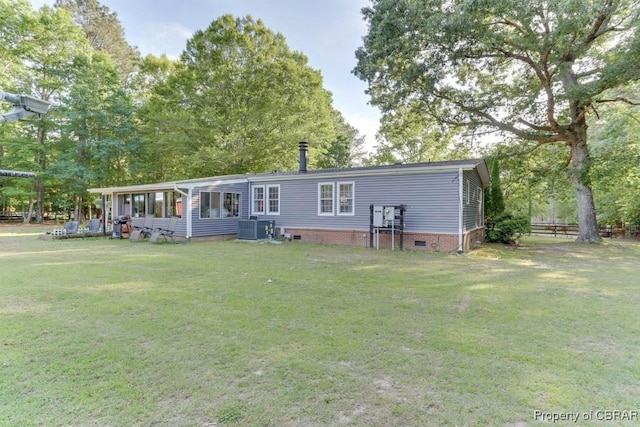 9361 Sheldon Ln, Gloucester, VA 23061 - back of property featuring a lawn, cooling unit, and crawl space