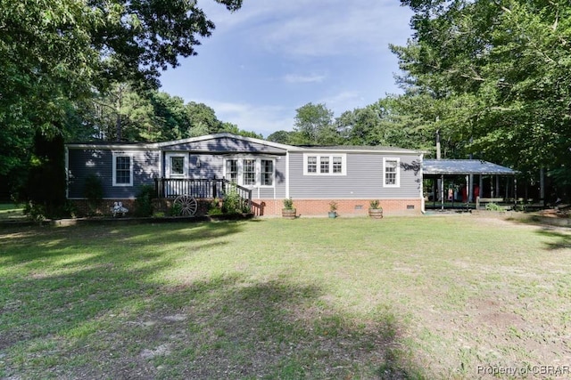 9361 Sheldon Ln, Gloucester, VA 23061 - rear view of house featuring crawl space, a carport, and a lawn