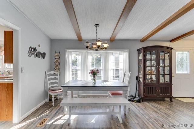 9361 Sheldon Ln, Gloucester, VA 23061 - dining area with a chandelier, wood finished floors, and beamed ceiling