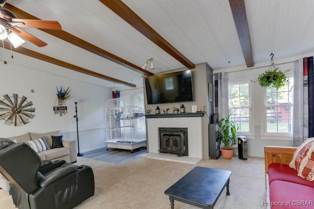 9361 Sheldon Ln, Gloucester, VA 23061 - carpeted living room featuring beamed ceiling, ceiling fan, and a fireplace