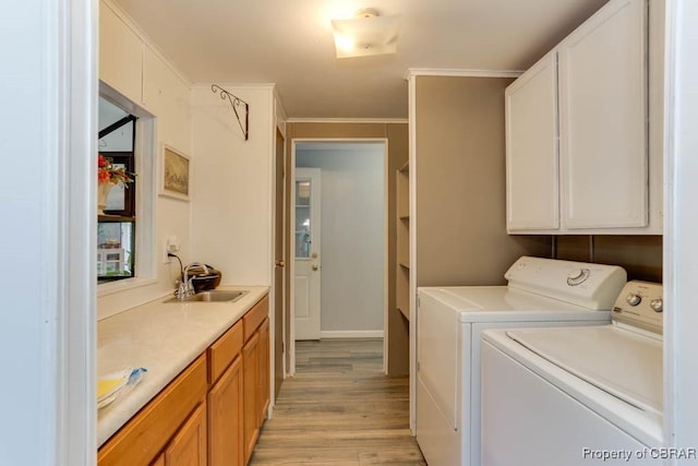 9361 Sheldon Ln, Gloucester, VA 23061 - laundry area with cabinet space, washing machine and clothes dryer, light wood-type flooring, and crown molding