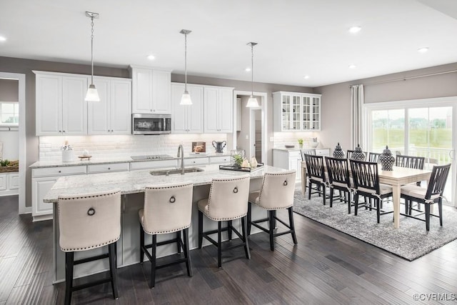 13006 Abercrombie Dr, Chesterfield, VA 23838 - kitchen featuring stainless steel microwave, decorative backsplash, white cabinets, a sink, and recessed lighting