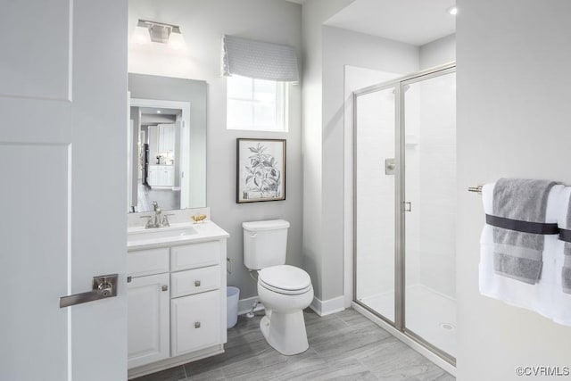 13006 Abercrombie Dr, Chesterfield, VA 23838 - bathroom with toilet, a stall shower, vanity, wood finished floors, and baseboards
