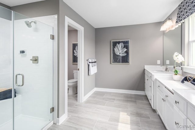 13006 Abercrombie Dr, Chesterfield, VA 23838 - bathroom featuring double vanity, baseboards, toilet, and a stall shower