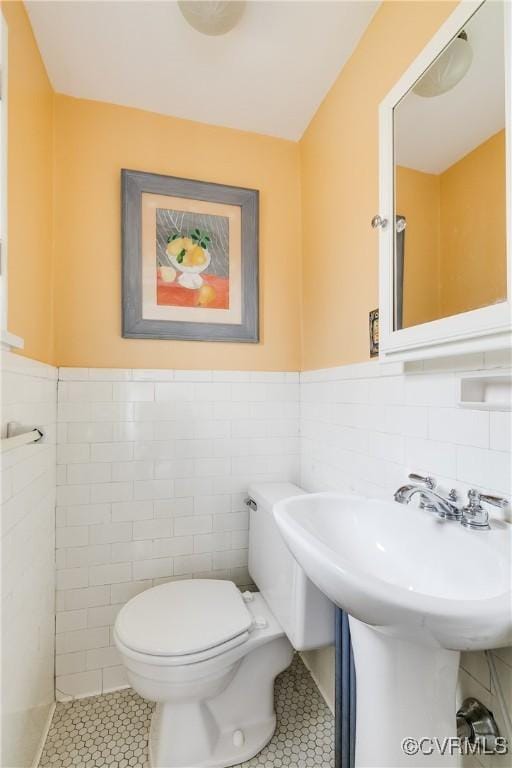 4318 Stuart Ave, Richmond, VA 23221 - bathroom featuring tile patterned flooring, tile walls, toilet, and wainscoting