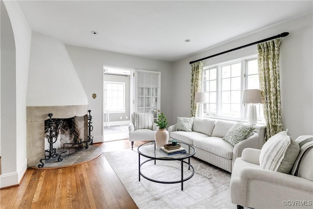 4318 Stuart Ave, Richmond, VA 23221 - living room with healthy amount of natural light, wood finished floors, baseboards, and a fireplace
