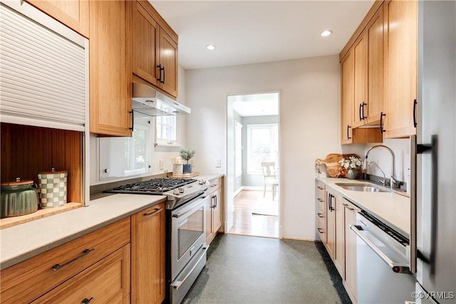4318 Stuart Ave, Richmond, VA 23221 - kitchen featuring under cabinet range hood, a sink, stainless steel gas range oven, dishwashing machine, and light countertops