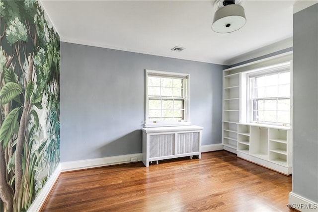4318 Stuart Ave, Richmond, VA 23221 - spare room featuring radiator heating unit, wood finished floors, baseboards, and ornamental molding
