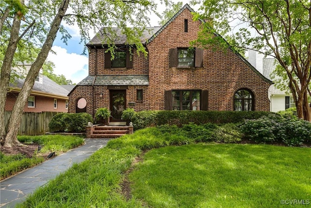 4318 Stuart Ave, Richmond, VA 23221 - tudor-style house featuring brick siding and a chimney