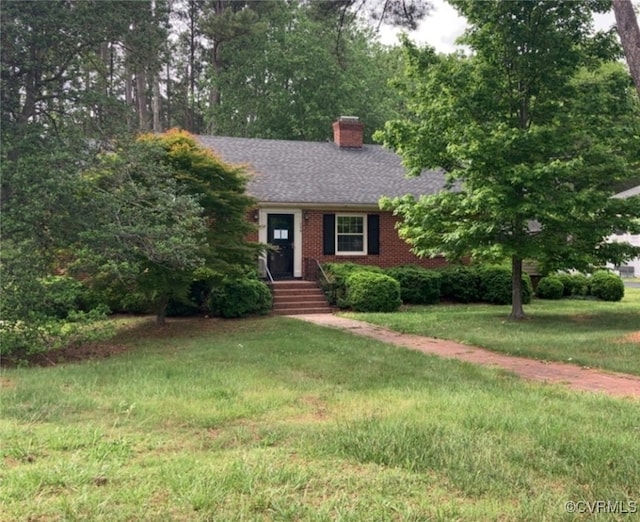 726 S Broad St, Kenbridge, VA 23944 - view of front of home featuring a chimney, a front yard, brick siding, and a shingled roof