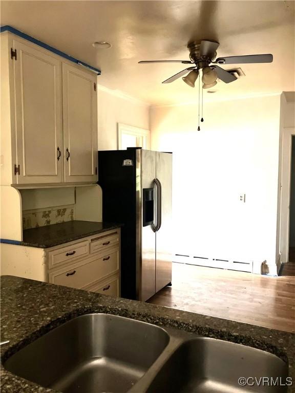 726 S Broad St, Kenbridge, VA 23944 - kitchen featuring stainless steel fridge, a ceiling fan, dark stone countertops, and white cabinetry