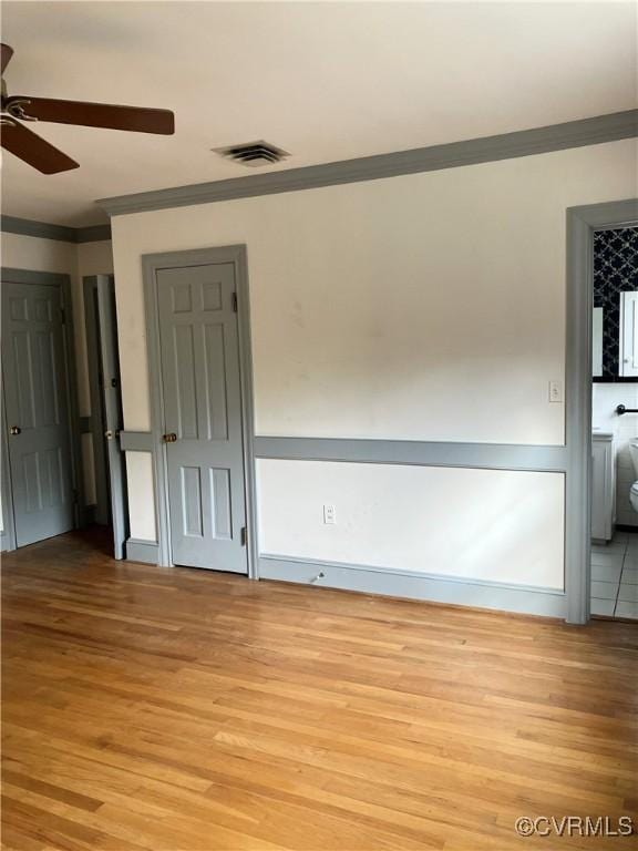 726 S Broad St, Kenbridge, VA 23944 - unfurnished bedroom with ornamental molding and light wood-style floors