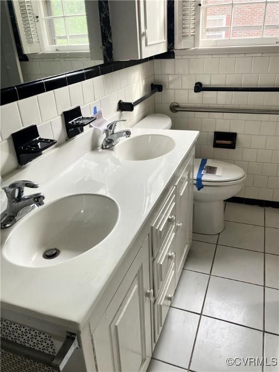 726 S Broad St, Kenbridge, VA 23944 - bathroom featuring tile patterned floors, double vanity, toilet, and tile walls