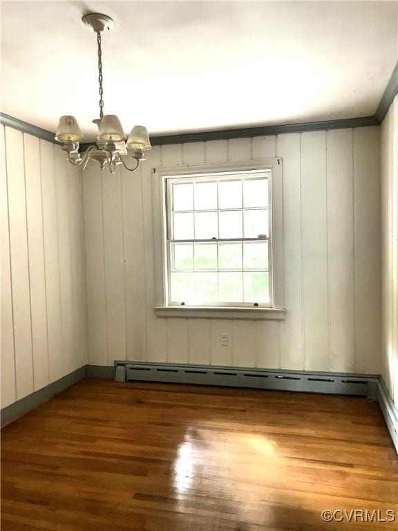 726 S Broad St, Kenbridge, VA 23944 - spare room with a chandelier, wood finished floors, and a baseboard radiator