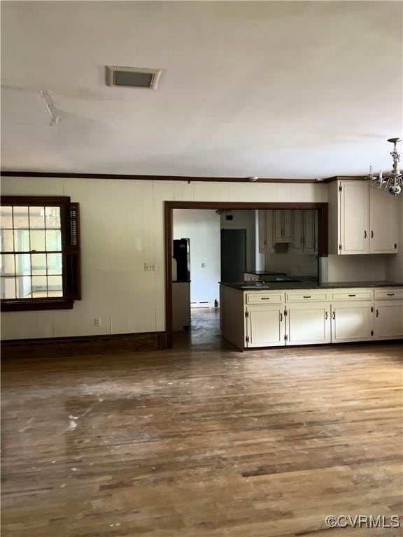 726 S Broad St, Kenbridge, VA 23944 - kitchen with dark countertops, wood finished floors, and crown molding