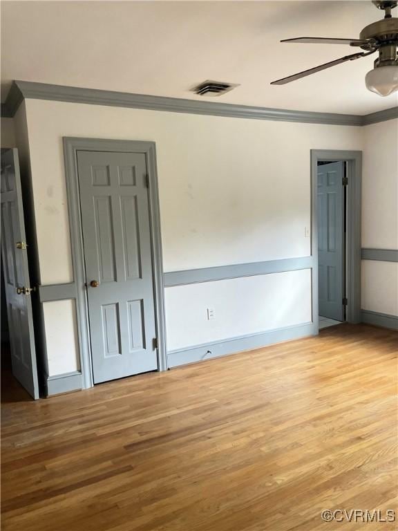 726 S Broad St, Kenbridge, VA 23944 - empty room featuring a ceiling fan, ornamental molding, wood finished floors, and baseboards