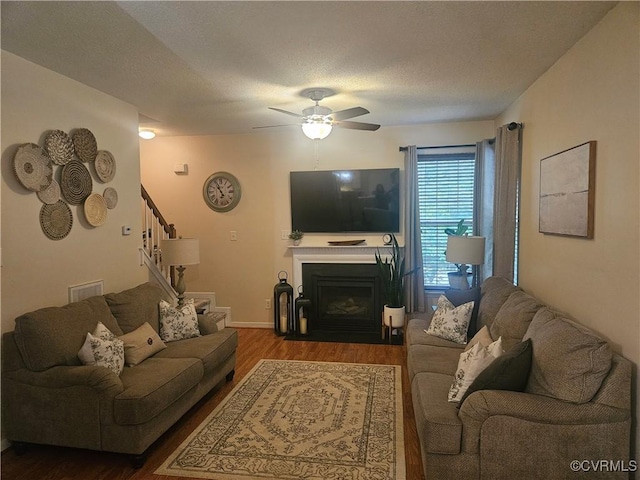 6778 Sassafras Dr, Quinton, VA 23141 - living area with wood finished floors, a ceiling fan, stairs, and a fireplace with flush hearth