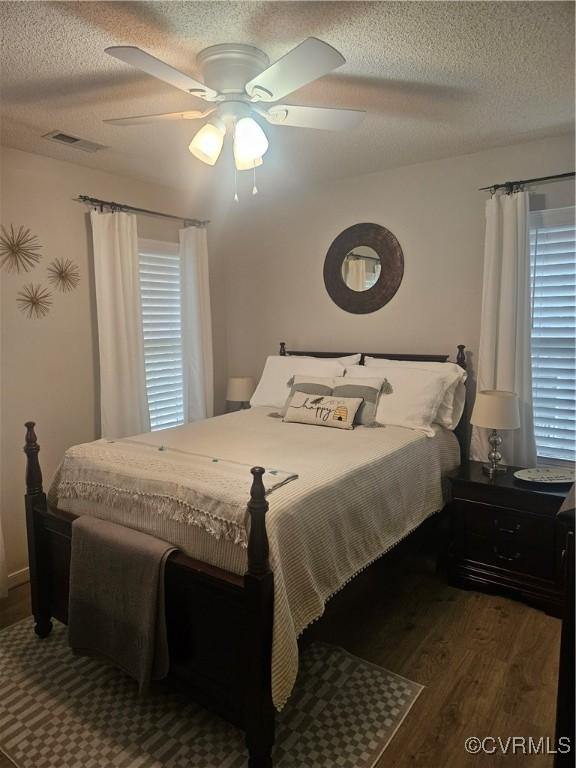 6778 Sassafras Dr, Quinton, VA 23141 - bedroom with wood finished floors, a textured ceiling, and a ceiling fan