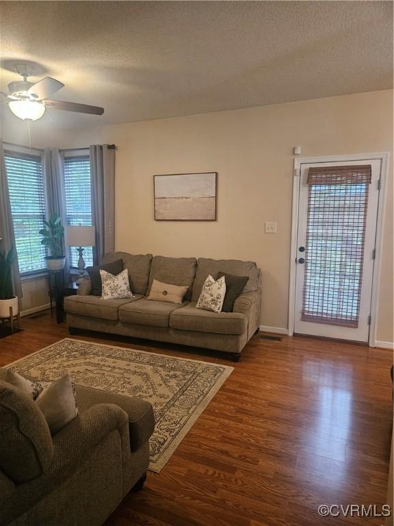 6778 Sassafras Dr, Quinton, VA 23141 - living room featuring wood finished floors, ceiling fan, baseboards, and a textured ceiling