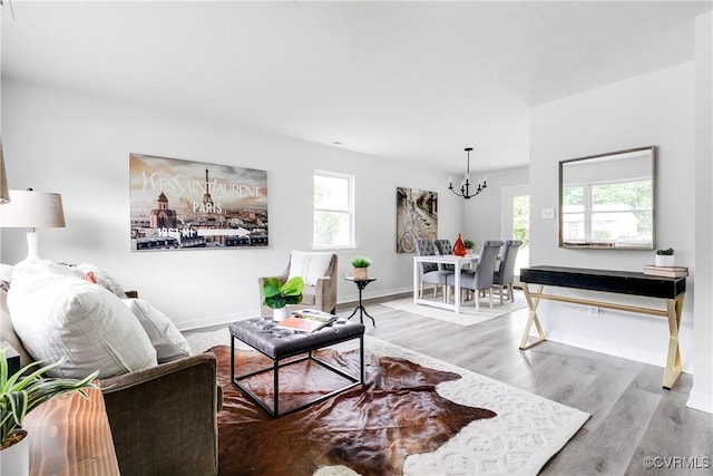 2222 Binford Ln, Richmond, VA 23223 - living area featuring a chandelier, wood finished floors, and baseboards