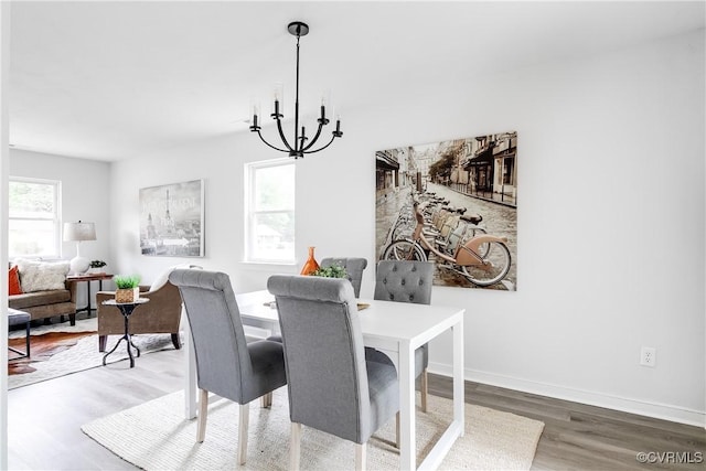 2222 Binford Ln, Richmond, VA 23223 - dining space with wood finished floors, a chandelier, and baseboards
