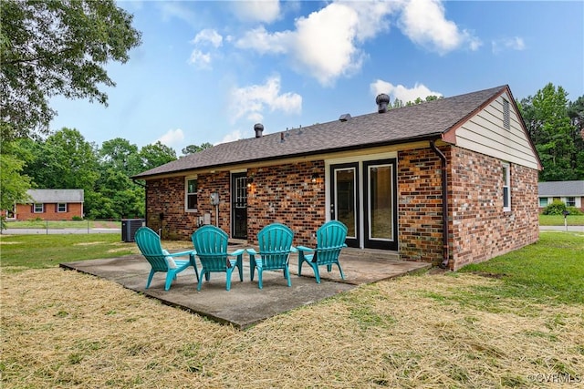 2222 Binford Ln, Richmond, VA 23223 - rear view of property with brick siding, a patio, cooling unit, and a lawn