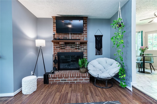 4710 Mason Rest Ct, Chesterfield, VA 23234 - living area with baseboards, a textured ceiling, wood finished floors, a brick fireplace, and a ceiling fan