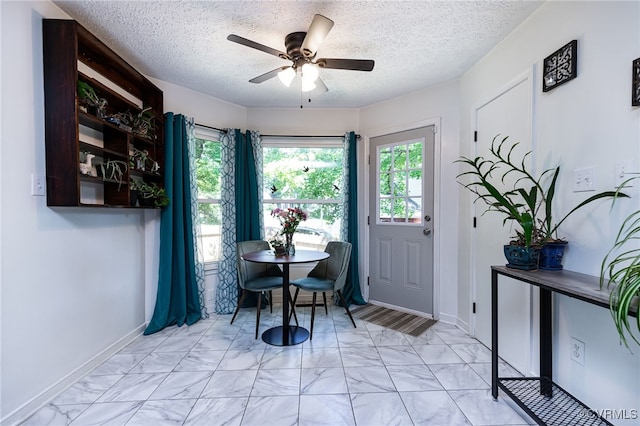 4710 Mason Rest Ct, Chesterfield, VA 23234 - dining area featuring light marble finish flooring, ceiling fan, a textured ceiling, and baseboards