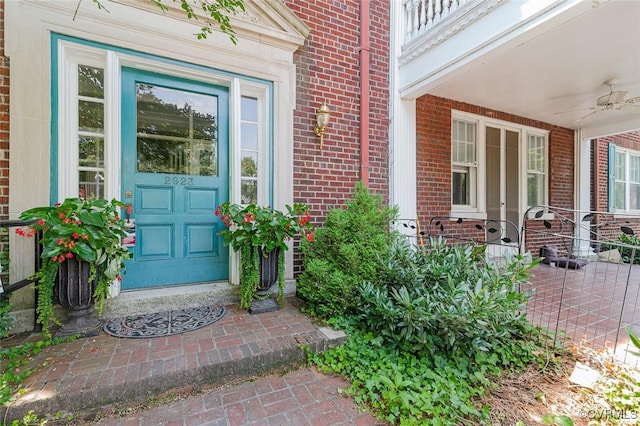 2923 Monument Ave Unit 1, Richmond, VA 23221 - doorway to property featuring brick siding, ceiling fan, and covered porch