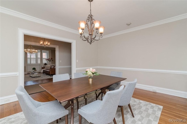 2923 Monument Ave Unit 1, Richmond, VA 23221 - dining room featuring a chandelier, crown molding, wood finished floors, and baseboards