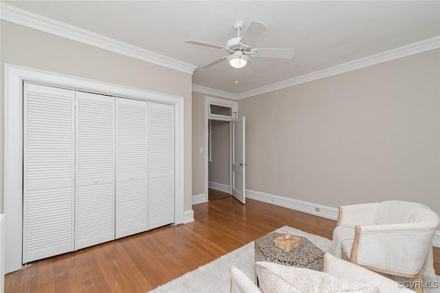 2923 Monument Ave Unit 1, Richmond, VA 23221 - living area featuring wood finished floors, ornamental molding, baseboards, and a ceiling fan