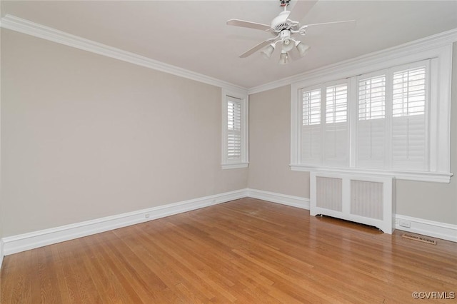 2923 Monument Ave Unit 1, Richmond, VA 23221 - unfurnished room featuring radiator, baseboards, light wood-style flooring, a ceiling fan, and crown molding
