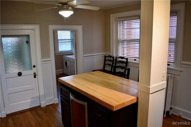 2923 Monument Ave Unit 1, Richmond, VA 23221 - dining space featuring washing machine and clothes dryer, ceiling fan, dark wood-style floors, wainscoting, and a decorative wall