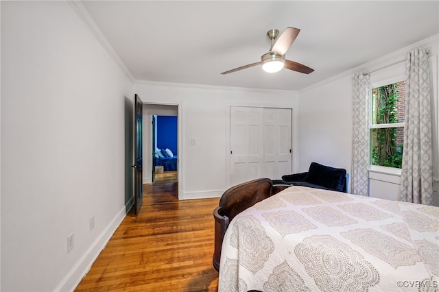 1743 Johnson Rd, Petersburg, VA 23805 - bedroom featuring crown molding, wood finished floors, a closet, baseboards, and a ceiling fan