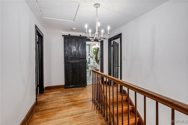1743 Johnson Rd, Petersburg, VA 23805 - hallway featuring an upstairs landing, light wood-style flooring, baseboards, and a chandelier