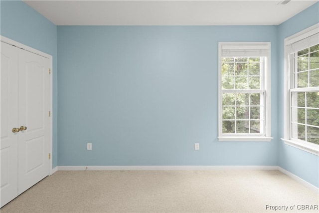 3907 Currier Ct, Chester, VA 23831 - unfurnished bedroom featuring multiple windows, light carpet, and baseboards