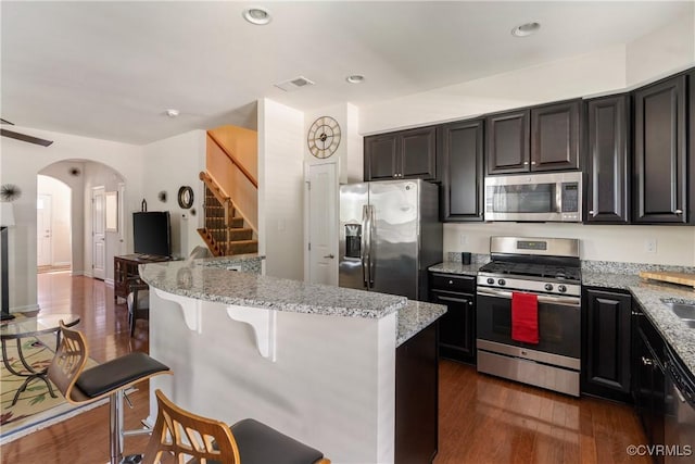 8910 Ringview Dr, Mechanicsville, VA 23116 - kitchen with stainless steel appliances, light stone countertops, a kitchen breakfast bar, dark wood-type flooring, and recessed lighting