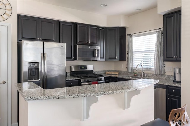 8910 Ringview Dr, Mechanicsville, VA 23116 - kitchen with appliances with stainless steel finishes, a sink, light stone countertops, dark cabinetry, and recessed lighting