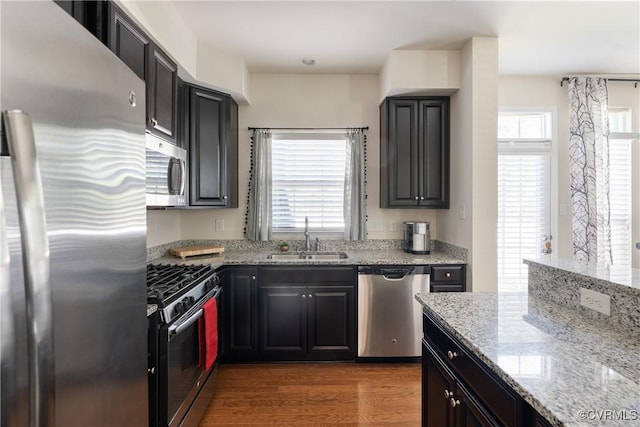 8910 Ringview Dr, Mechanicsville, VA 23116 - kitchen featuring stainless steel appliances, a sink, light stone counters, and wood finished floors