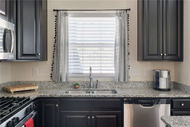 8910 Ringview Dr, Mechanicsville, VA 23116 - kitchen featuring appliances with stainless steel finishes, a sink, light stone counters, and dark cabinets