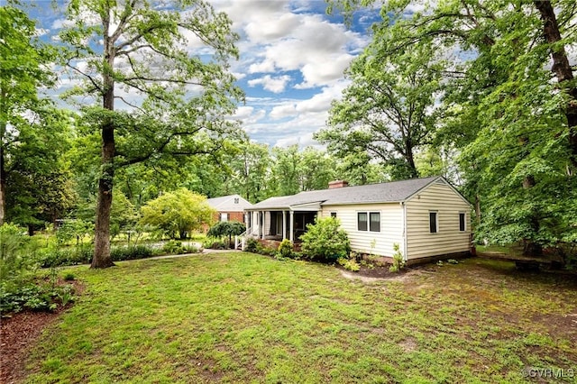 1708 Michaels Rd, Henrico, VA 23229 - rear view of house with a lawn, a chimney, and a sunroom