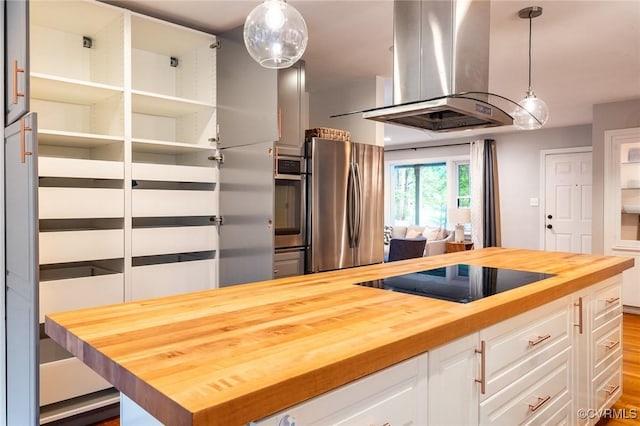 1708 Michaels Rd, Henrico, VA 23229 - kitchen with butcher block counters, stainless steel appliances, island range hood, white cabinetry, and decorative light fixtures