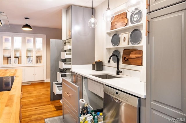1708 Michaels Rd, Henrico, VA 23229 - kitchen featuring stainless steel dishwasher, a sink, light wood-style floors, hanging light fixtures, and butcher block counters